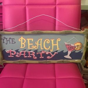 The Beach Party “has started” or “is over” wooden sign.